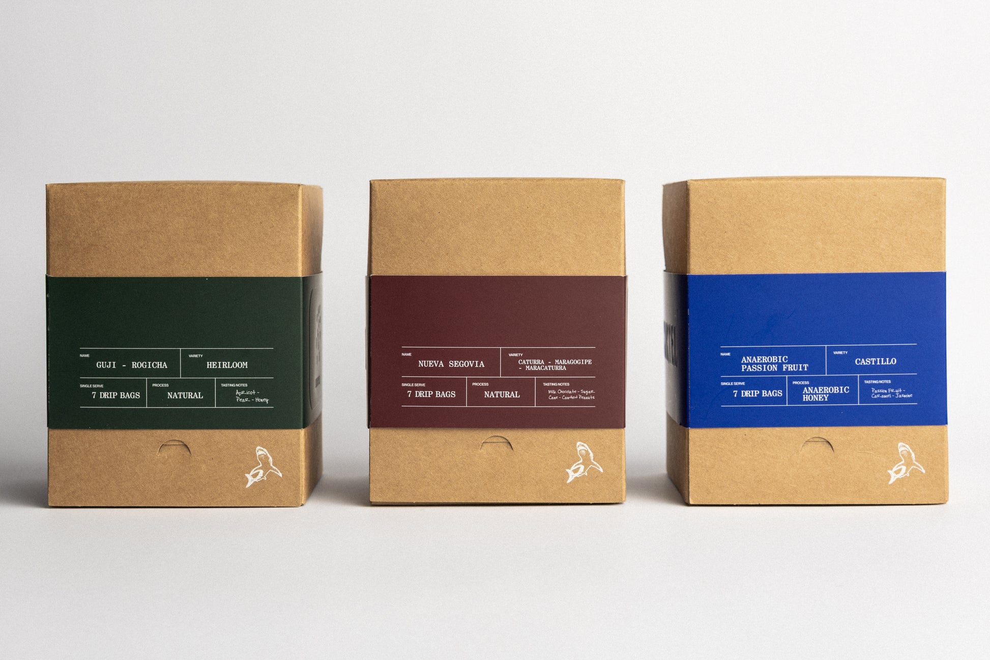 Three cardboard boxes with different colored labels on a white background